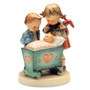M.I. Hummel figurine HUM 333 Blessed Event featuring a big brother and sister looking at a newborn baby in a cradle, handcrafted in Germany.