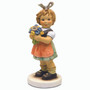 Close-up of the hand-painted yellow and blue flowers on the M.I. Hummel 2282/A figurine. Precious Bouquet HUM 2282/A M.I. Hummel figurine of a girl holding yellow and blue blossoms.