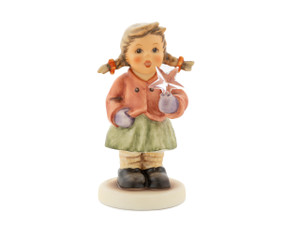 M.I. Hummel Swarovski Series figurine of a girl holding a 5-pointed Swarovski crystal star.