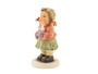Close-up of the brilliant Swarovski crystal star held by the M.I. Hummel girl figurine.