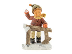 Close-up of the genuine Swarovski crystals held by the M.I. Hummel Wintertime Fun boy figurine.