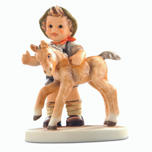 M.I. Hummel 'Curious Colt' figurine HUM 2311 showing a young boy bonding with a small brown horse.