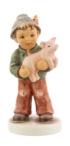 M.I. Hummel 'Prized Pig' figurine (HUM 2325) showing a young boy in overalls holding up a small pink pig.  A close-up of the boy’s proud expression and the 2011 TMK-9 backstamp on the base of the Prized Pig figurine.