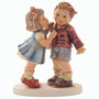 First Kiss HUM 2337 M.I. Hummel figurine of a young girl kissing a surprised boy on the cheek. Close-up of the girl on her tippy toes from the M.I. Hummel First Kiss figurine.