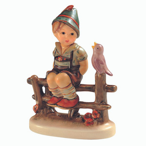 M.I. Hummel 'Wayside Harmony' (HUM 111 3/0) featuring a boy in lederhosen sitting on a fence with a bird. A close-up of the songbird and the intricate wood-grain detail of the fence on Wayside Harmony.