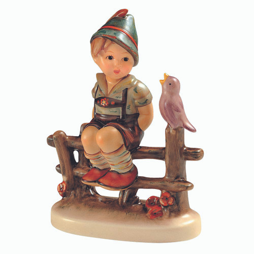 M.I. Hummel 'Wayside Harmony' (HUM 111 3/0) featuring a boy in lederhosen sitting on a fence with a bird. A close-up of the songbird and the intricate wood-grain detail of the fence on Wayside Harmony.