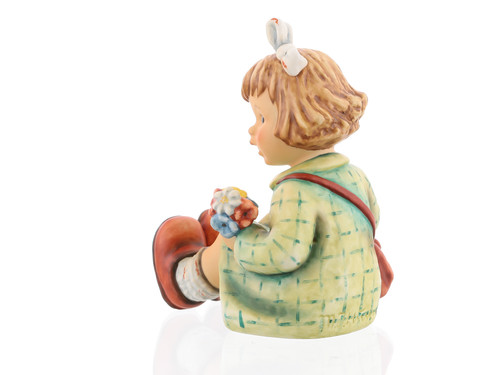 M.I. Hummel figurine HUM 2317/A "What a Day" featuring a blonde girl in a green dress taking a hiking break.