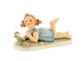 Close-up of the mischievous expression on the 10th Anniversary Hummel Miss Beehaving figurine.