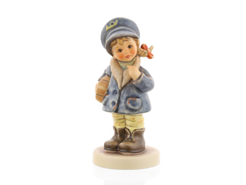 M.I. Hummel 'Little Miss Mail Carrier' (HUM 2120) featuring a young girl in a blue postal cap and winter coat carrying a brown package.