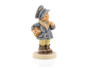 A close-up of the mail carrier's rosy red cheeks and the hand-painted details of her heavy winter boots and parcel.