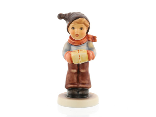 M.I. Hummel 'For Me?' figurine (HUM 2067/B) showing a boy in a red scarf holding a gold gift box. A close-up of the gold-wrapped package and the red twine detail