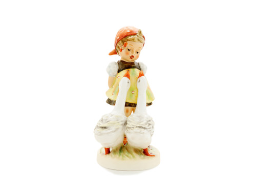 The famous M.I. Hummel 'Goose Girl' figurine (HUM 47) featuring a girl in a polka-dot kerchief with two geese.