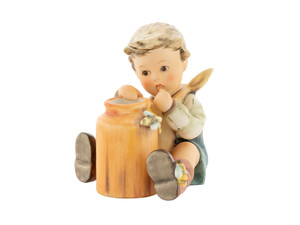 M.I. Hummel 'Honey Lover' (HUM 312/I) 15th Anniversary Club Exclusive featuring a young boy with a spoon and a jar of honey.