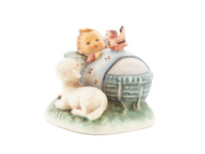 M.I. Hummel figurine HUM 455 The Guardian featuring a baby in a cradle with a lamb and a singing bird nearby, handcrafted in Germany.