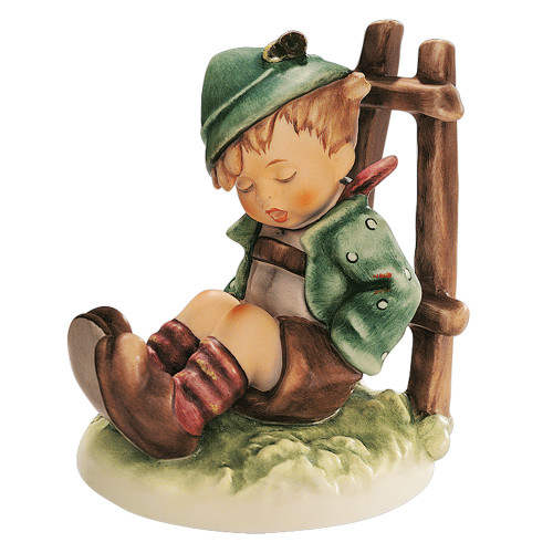 M.I. Hummel 'Afternoon Nap' figurine HUM 836 showing a young hiker boy asleep on the grass with his walking stick.
