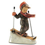 Skier HUM 59 M.I. Hummel figurine of a young boy with wooden skis and poles. Close-up of the vintage-style skis and hand-painted winter gear on the M.I. Hummel Skier.
