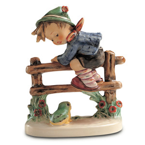 Hand-painted M.I. Hummel figurine 'Retreat to Safety' featuring a young boy in a hat climbing a fence to escape a small green frog.