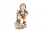 M.I. Hummel 'Trail Blazer' figurine HUM 2045 showing a young boy hiker with a backpack and walking stick.
Detail of the hand-painted edelweiss flower and blue hat feather on the Trail Blazer Hummel.