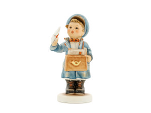 M.I. Hummel 'The Postman' (HUM 119/0) featuring a boy in a blue postal uniform and cap carrying a brown mailbag full of letters.