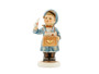 M.I. Hummel 'The Postman' (HUM 119/0) featuring a boy in a blue postal uniform and cap carrying a brown mailbag full of letters.
