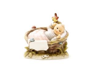 M.I. Hummel 'Wake up Girl' figurine (HUM 656) shows a baby girl stretching in a basket with a red blanket and a yellow bird.