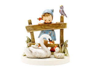 M.I. Hummel figurine HUM 344 Feathered Friends featuring a young girl with wind-swept hair leaning over a fence to watch birds, handcrafted in Germany.