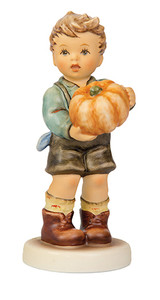 M.I. Hummel's 'Sweet Bounty' (HUM 2382) Club Exclusive featuring a young boy in lederhosen carrying a large, hand-painted orange pumpkin.