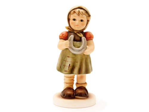 M.I. Hummel figurine HUM 2379 My Little Horseshoe, part of the Luck Series, featuring a boy holding a golden lucky horseshoe, handcrafted in Germany.
