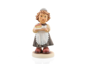 A close-up of the delicate porcelain tray, the hand-painted slice of cake, and the girl’s traditional apron and headpiece. M.I. Hummel 'Maid to Order' (HUM 2091) featuring a young girl in a black and white maid uniform carrying a tray with a teapot and cake.