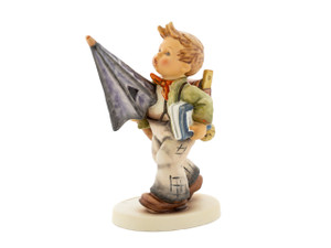 M.I. Hummel Is It Raining? HUM 420 porcelain figurine of a schoolboy with rare blue eyes holding an umbrella and books.
