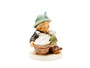 Detailed view of the two bunnies inside the basket on the hand-painted Playmates Hummel figurine.