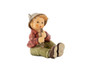 Close-up of the intricate hand-painted flute and humble expression on the M.I. Hummel Shepherd. Shepherd with Flute HUM 2230/F M.I. Hummel Nativity figurine playing a wooden flute.