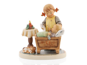 M.I. Hummel figurine HUM 2390 Light the First Candle featuring a sister tending to a baby in a cradle by an Advent candle with a sleeping cat.