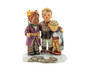 M.I. Hummel figurine HUM 2412 Carolers featuring three children singing Christmas carols, including a sleepy boy named Caspar, handcrafted in Germany.