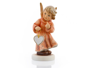M.I. Hummel Annual Angel 2018 Angel of Love figurine (HUM 2385) featuring a blue-eyed angel holding a ceramic heart, handcrafted in Germany