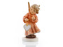M.I. Hummel Annual Angel 2018 Angel of Love figurine (HUM 2385) featuring a blue-eyed angel holding a ceramic heart, handcrafted in Germany
