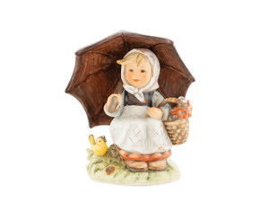 M.I. Hummel figurine HUM 408/I Smiling Through featuring a girl sitting under a large umbrella with a small bird, handcrafted in Germany.