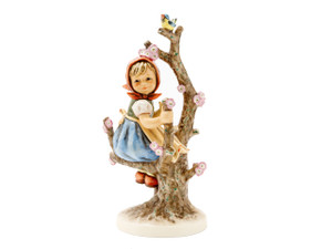 Iconic M.I. Hummel figurine HUM 141 of a girl sitting in an apple tree.