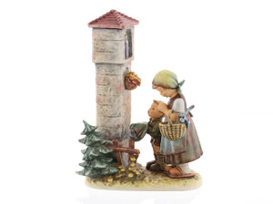 M.I. Hummel figurine HUM 572 Country Devotion featuring two children praying at a flower-decorated roadside shrine, a limited edition of 950 pieces.