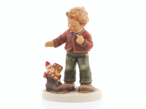 M.I. Hummel figurine HUM 2427 Sweet Surprise featuring a boy delighted by a boot filled with Christmas treats, handcrafted in Germany.
