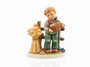 Close-up of the hand-painted grain sheaf and harvest basket on the M.I. Hummel 2439 figurine.