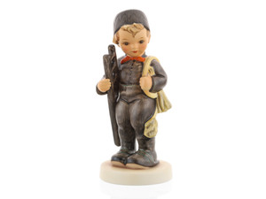 M.I. Hummel Chimney Sweep figurine (HUM 12/I) featuring a young boy in a traditional black uniform and cap holding a wooden ladder.