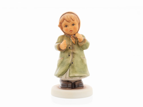 M.I. Hummel 'Keeping Time' figurine HUM 2183 featuring a girl in a green winter coat swaying to music.