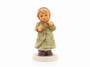 M.I. Hummel 'Keeping Time' figurine HUM 2183 featuring a girl in a green winter coat swaying to music.