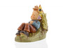 M.I. Hummel figurine HUM 550 Summerdream featuring a young boy napping in a grassy meadow with a small bird nearby, handcrafted in Germany.