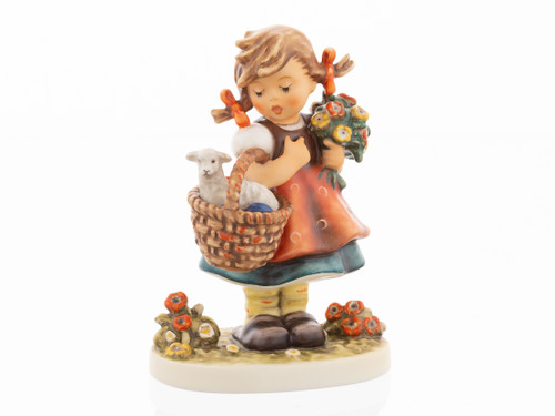 M.I. Hummel figurine HUM 928 Happy Easter featuring a young girl in a traditional dress carrying a basket with a small lamb, handcrafted in Germany.
