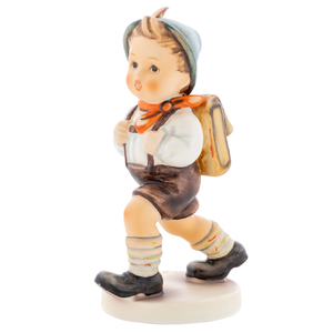 M.I. Hummel 'School Boy' (HUM 82 2/0) featuring a boy in a red cap carrying a brown school satchel on his back. A close-up of the textured school bag and the traditional feathered hat detail.