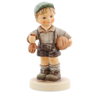 M.I. Hummel 'Keeper of the Goal' figurine HUM 2212 showing a boy with a soccer ball and goalie gloves. Close-up of the boy’s "sweaty" blond hair and rosy cheeks, highlighting the athletic detail.