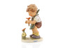 M.I. Hummel 'The Florist' (HUM 349/0) features a boy kneeling and picking colorful garden flowers into a basket.