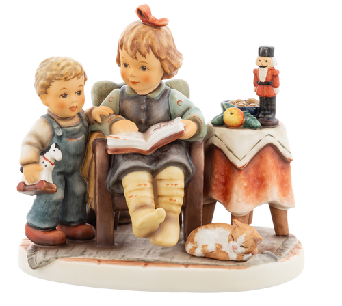 M.I. Hummel figurine HUM 2392 Christmas is Coming featuring siblings reading in an armchair with a Nutcracker and a sleeping cat, handcrafted in Germany.